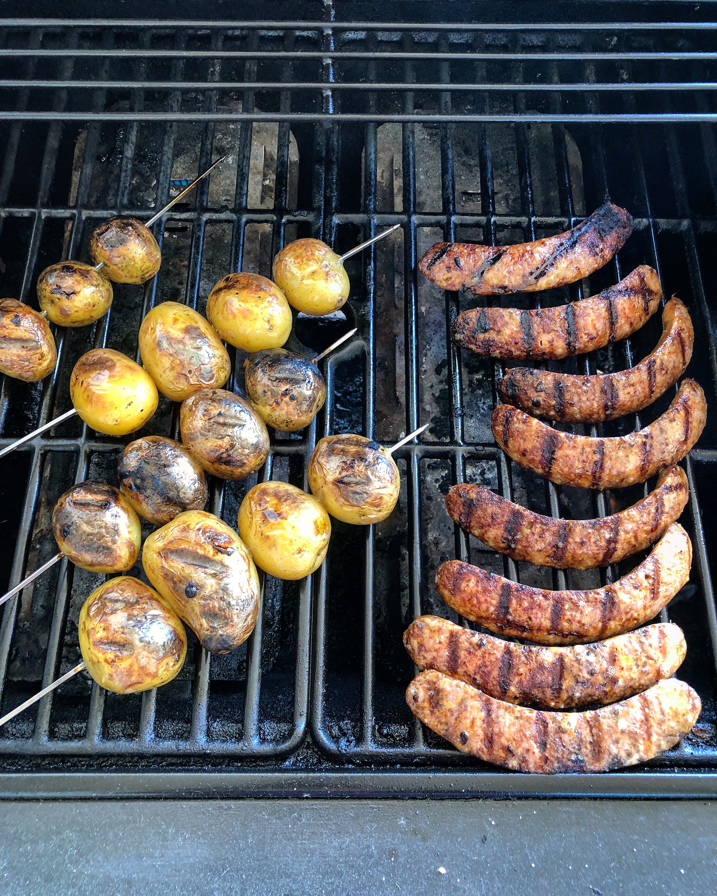 Grilling potatoes and sausages